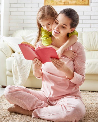 pretty young mother reading a book to her daughter